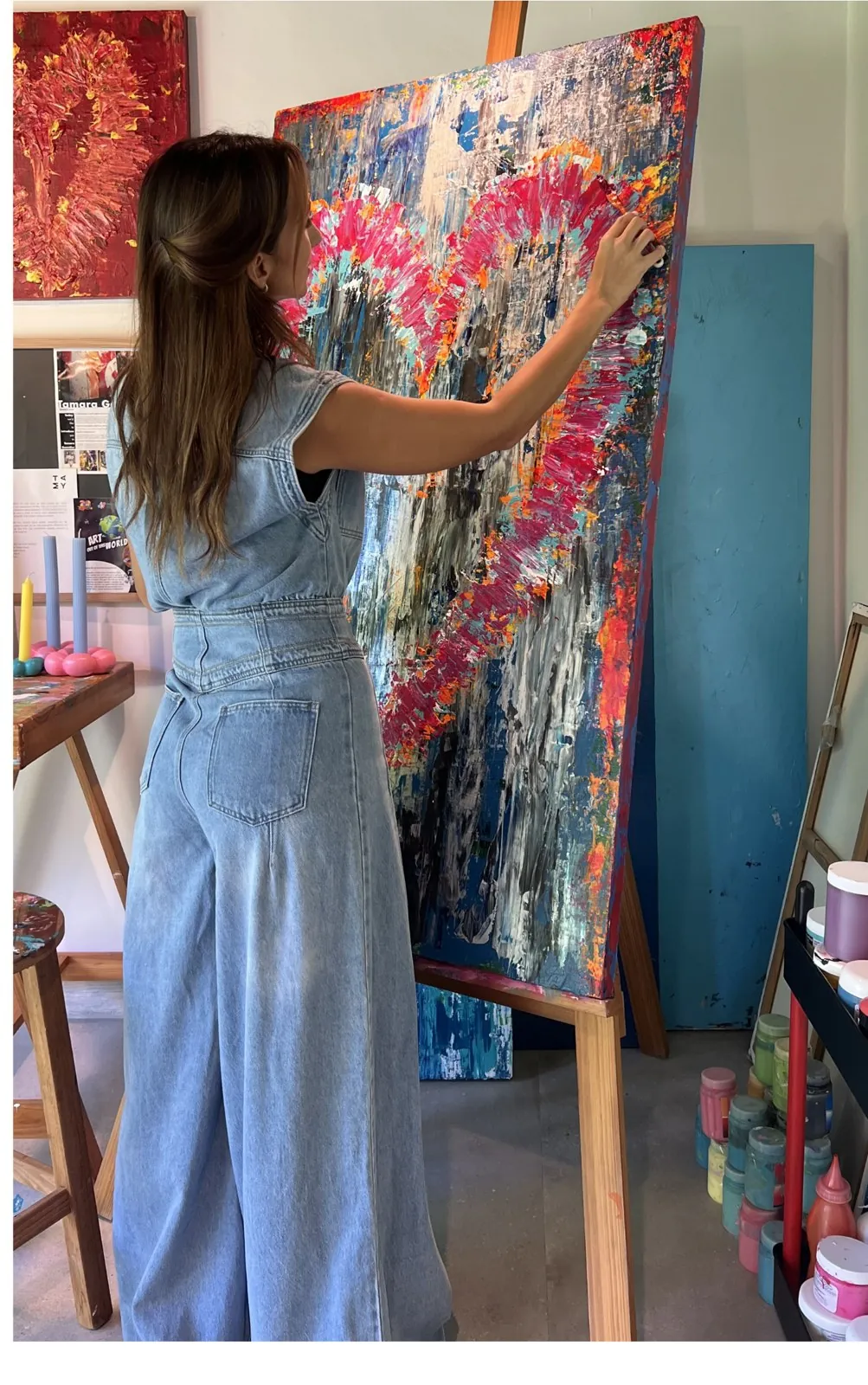 Tamy en el estudio, frente a una obra de gran formato